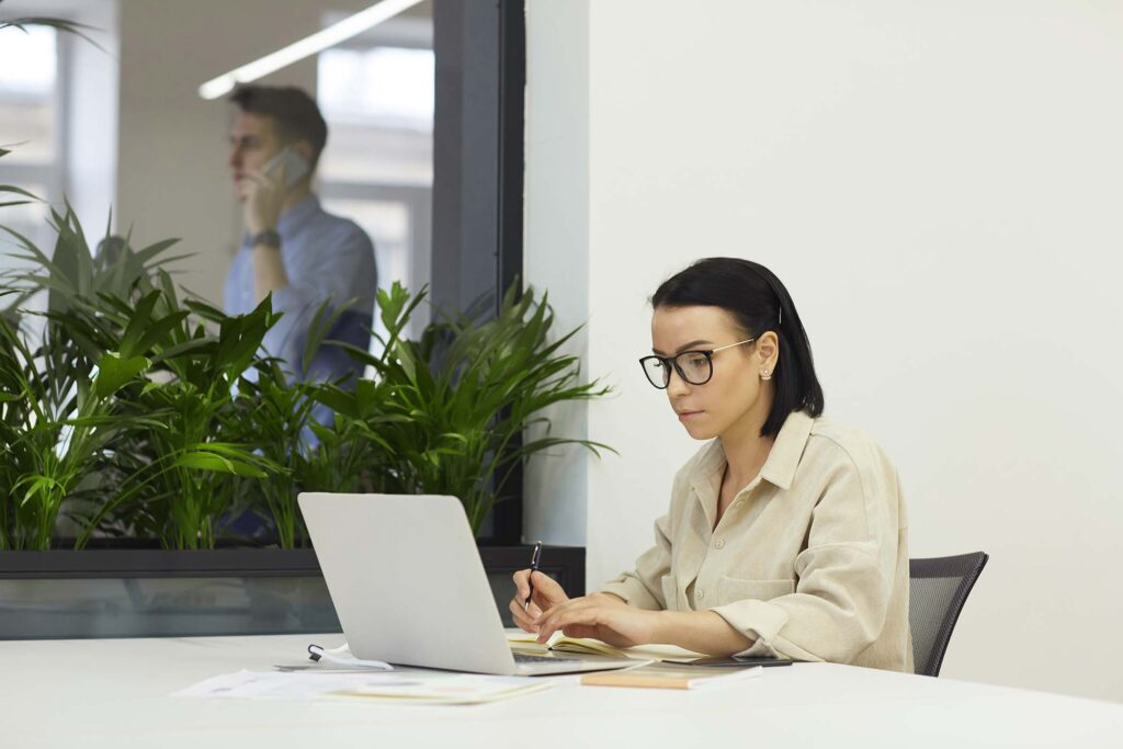 businesswoman-with-laptop-at-office-NVPWG6A.jpg